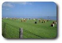 Deich von Burhave mit Strandkrben und Nordseeblick